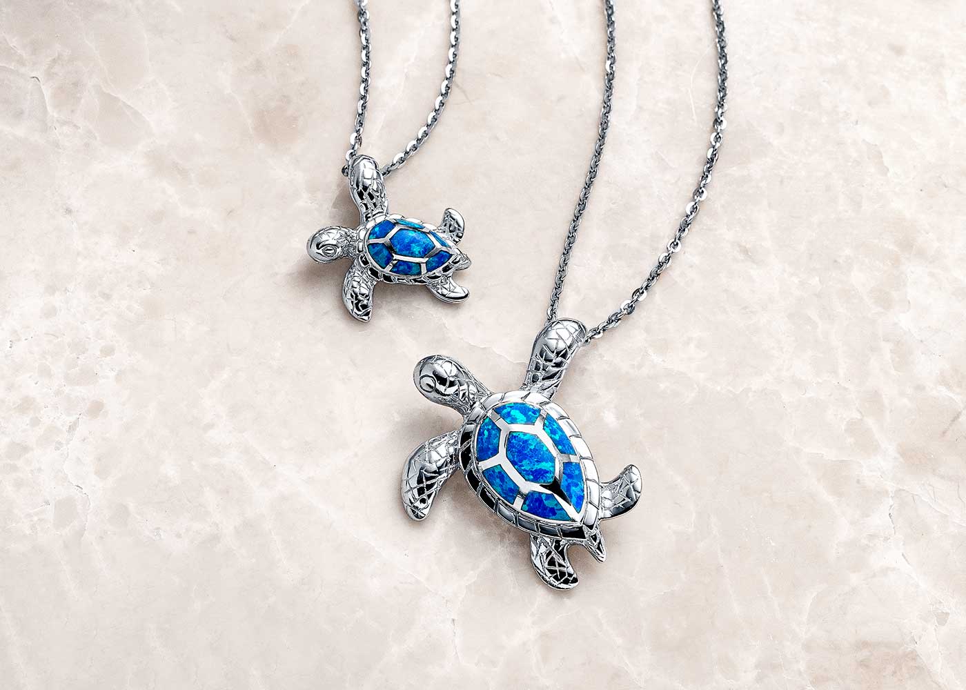 A Landing Company sea turtle pendant with luminous blue opal inlay — a study in patience and grace