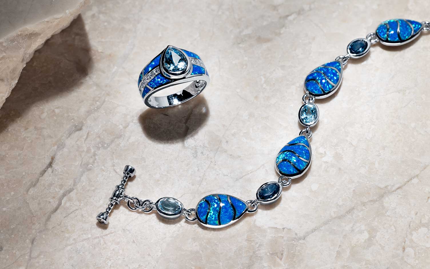 An artisan handsetting mosaic blue opal inlay