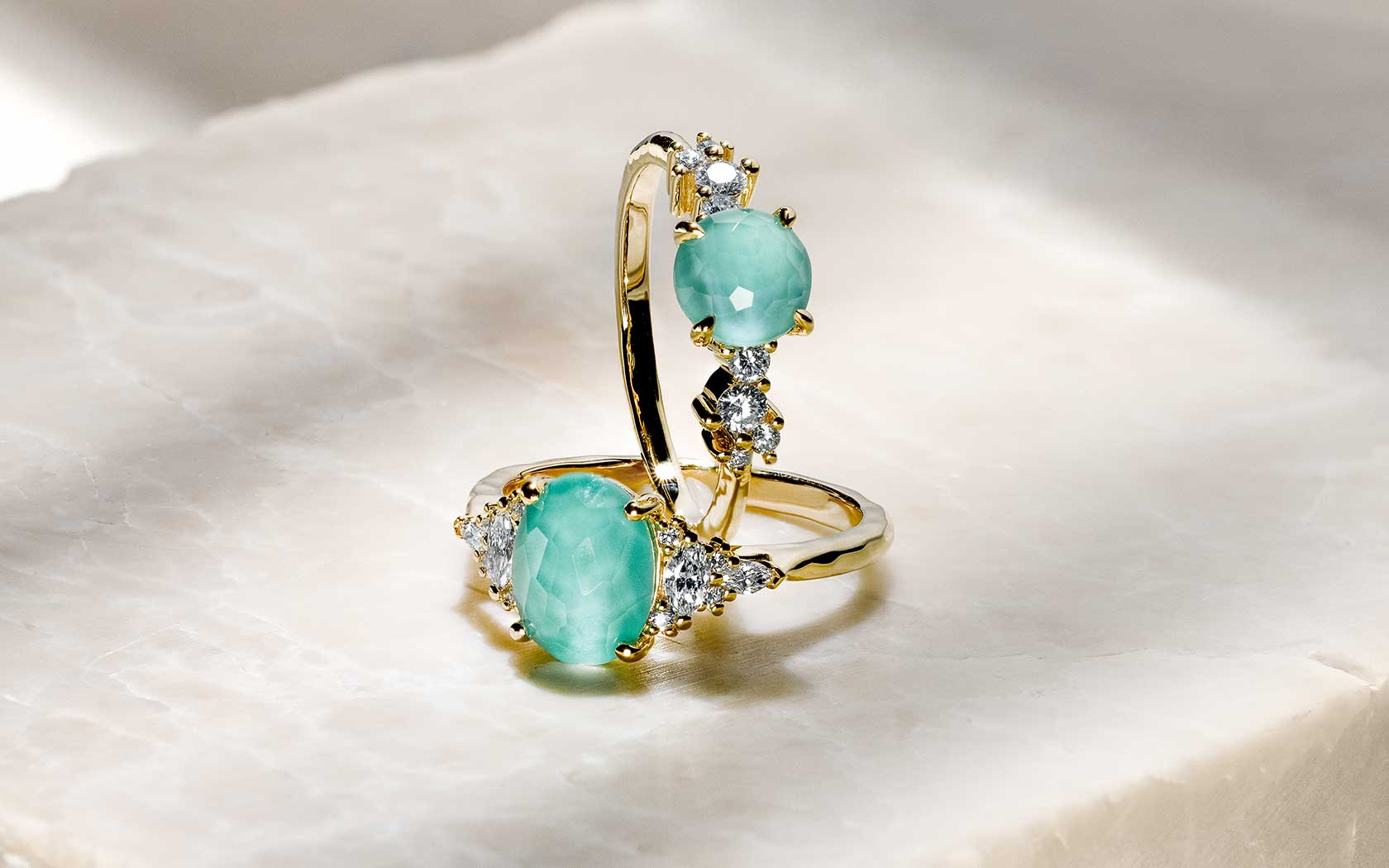 A Laguna ring with diamond accents and signature faceted color, set in 14k gold