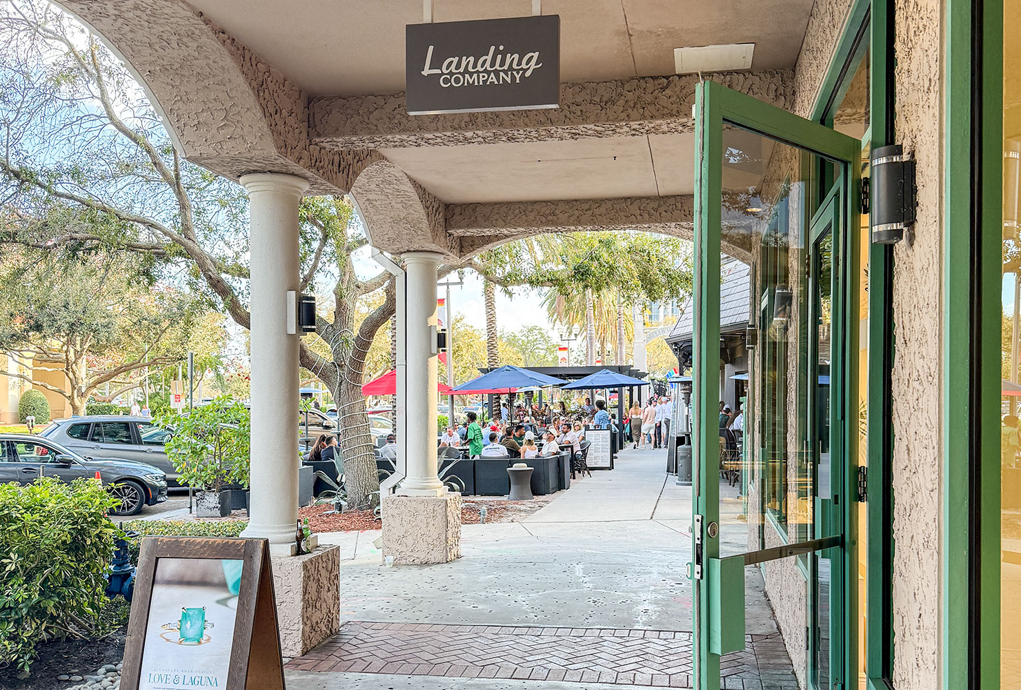 Landing Company Sidewalk View in Downtown St. Pete with A frame sign and bar area
